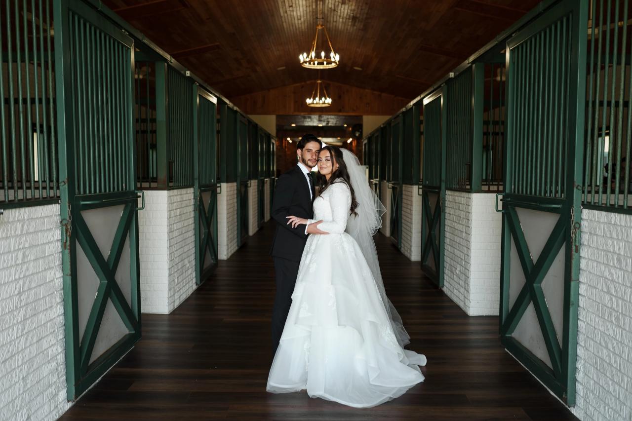 Bride and groom in a rustic stable corridor. Jewish wedding in Baltimore.