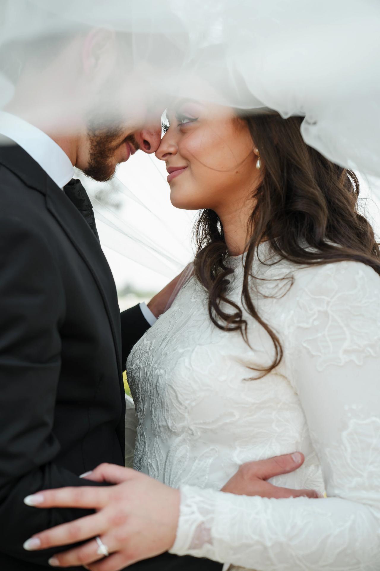 Close wedding portrait of the couple kissing beneath the veil. Jewish wedding in Baltimore.