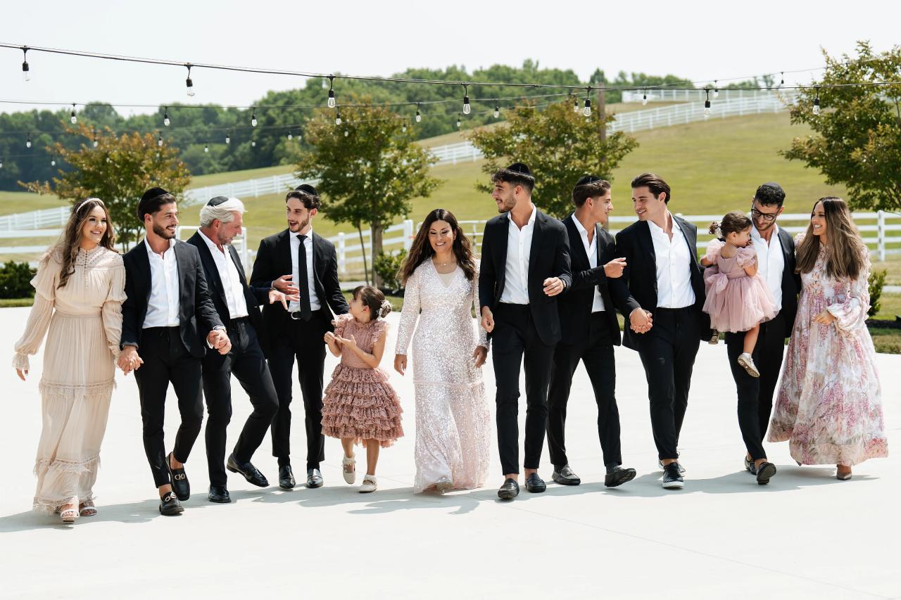 Wedding party walking together across the grounds. Jewish wedding in Baltimore.