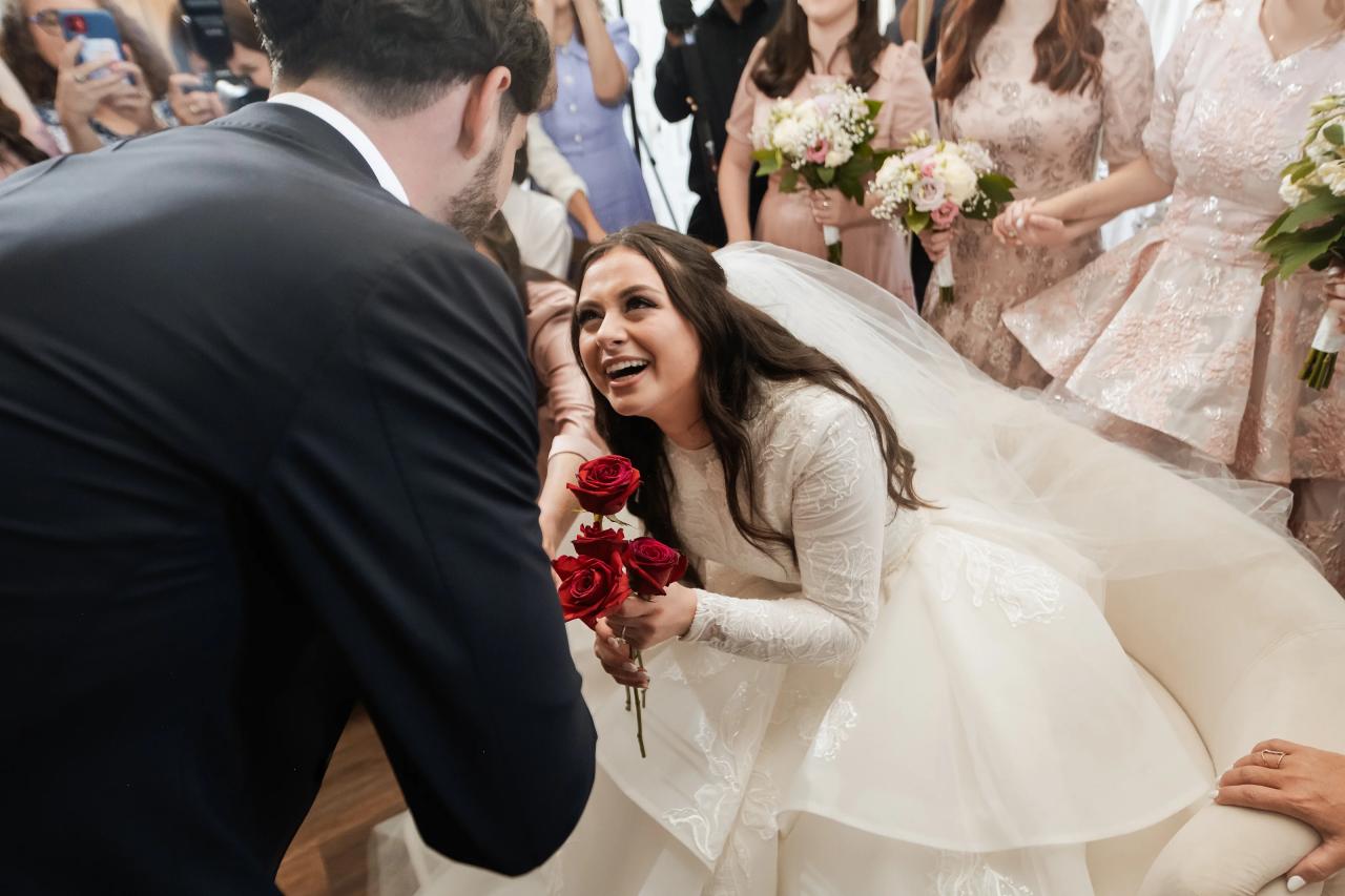 Groom greeting the seated bride during the badeken. Jewish wedding in Baltimore.