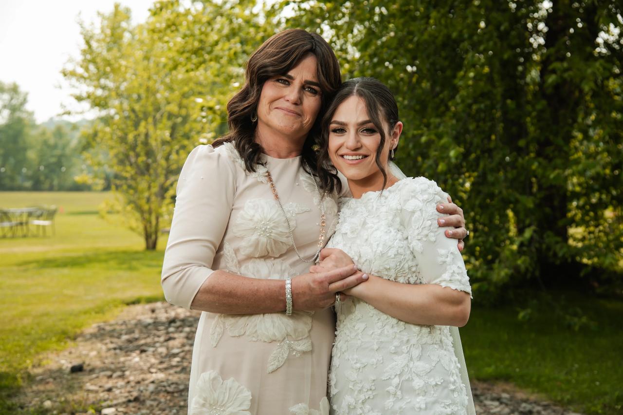 Bride sharing a portrait with a family member. Wedding at Indian Ridge.