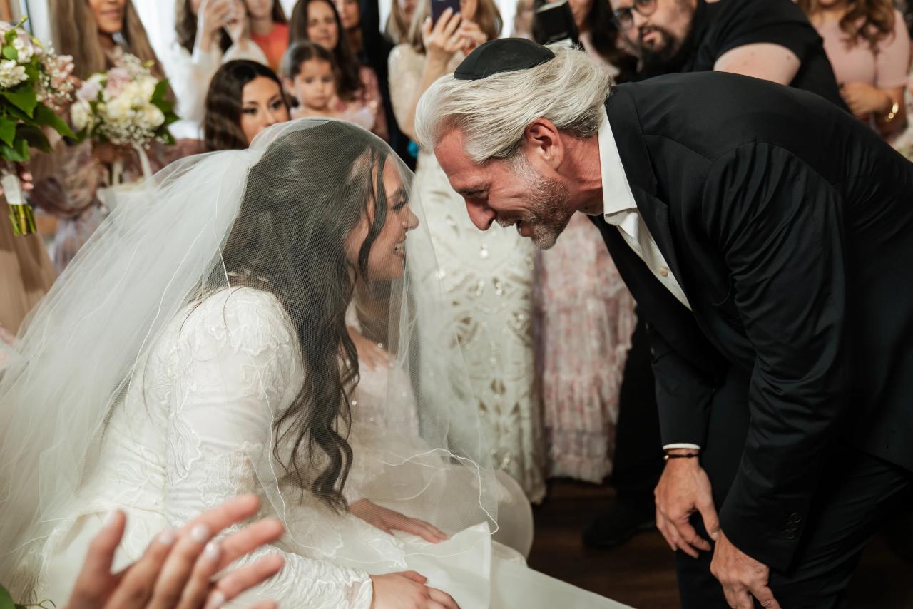 Father embracing the veiled bride before the ceremony. Jewish wedding in Baltimore.