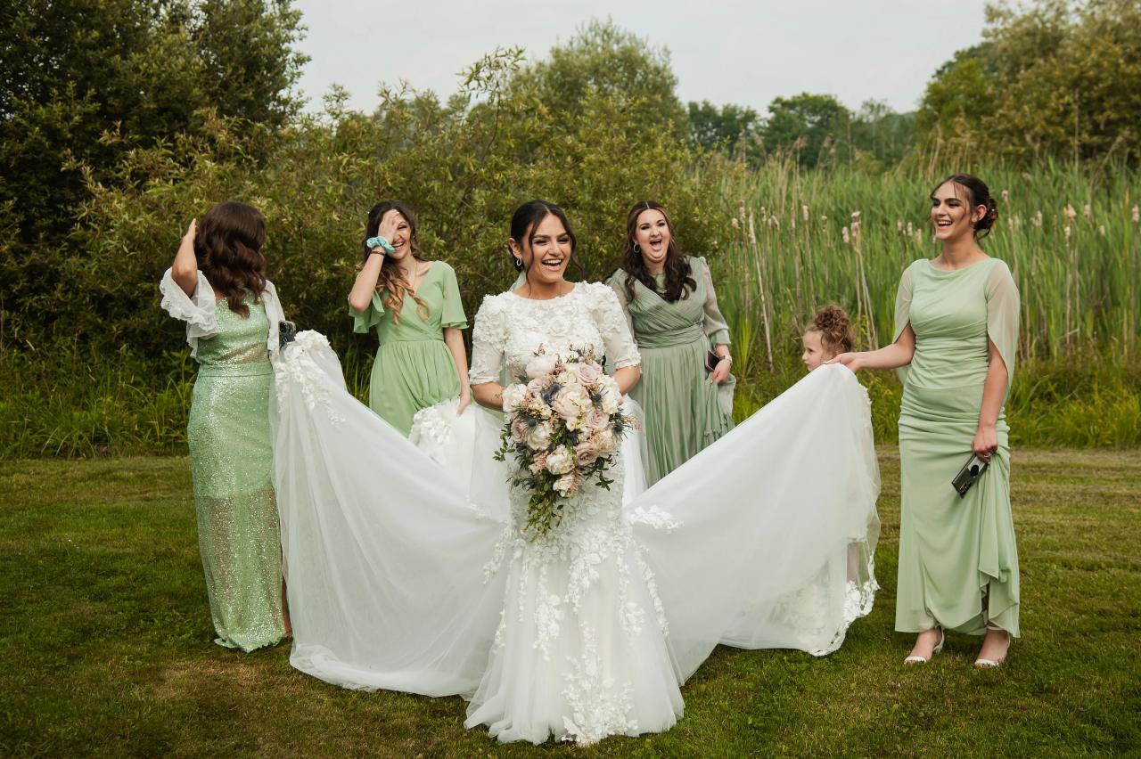Bride with her wedding party in soft green dresses. Wedding at Indian Ridge.