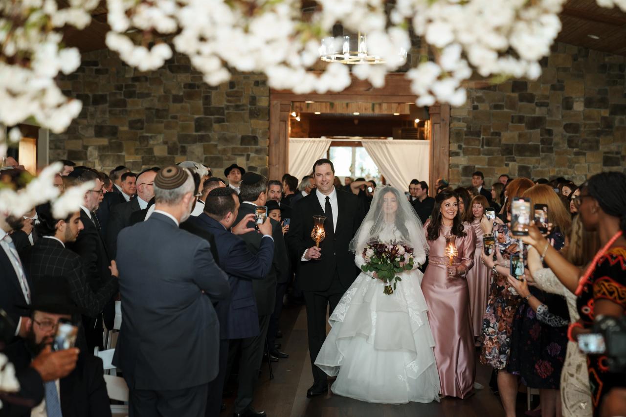 Bride entering the Jewish wedding ceremony with family. Jewish wedding in Baltimore.