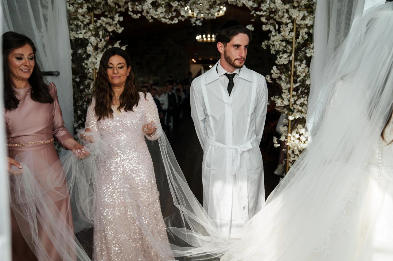 Bride and groom with family beneath the chuppah. Jewish wedding in Baltimore.