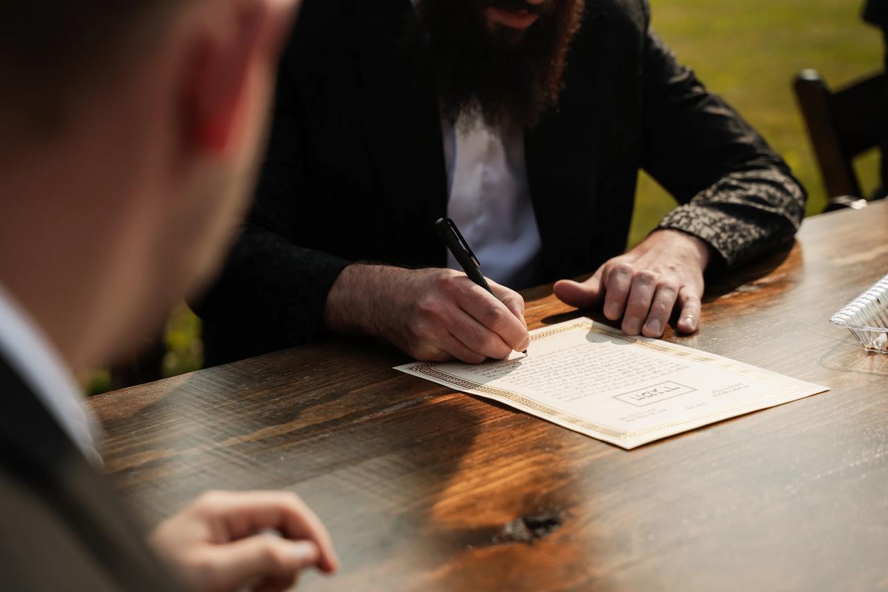 Close detail of the wedding ketubah being signed. Wedding at Indian Ridge.