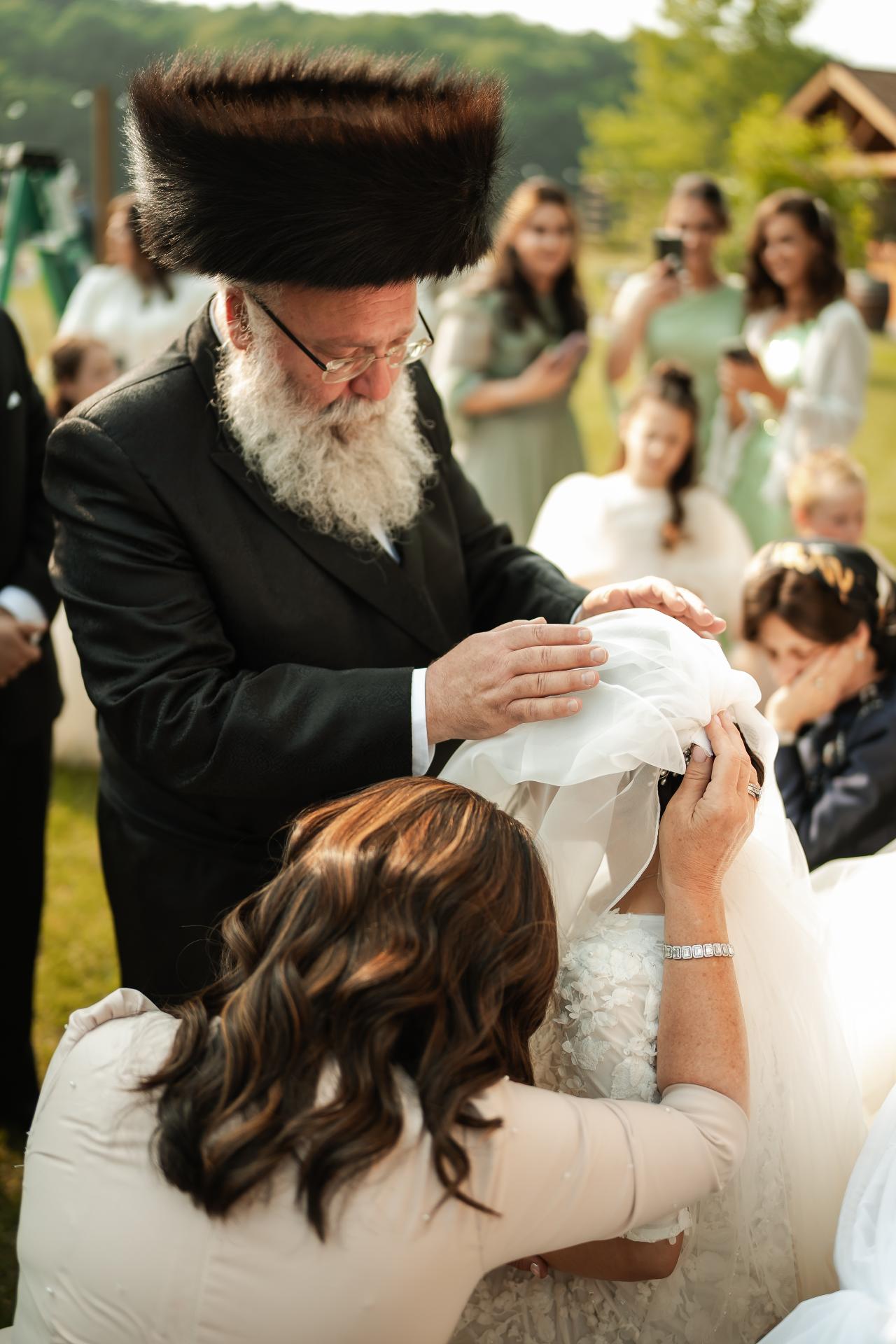 Family lowering the bridal veil before the wedding ceremony. Wedding at Indian Ridge.