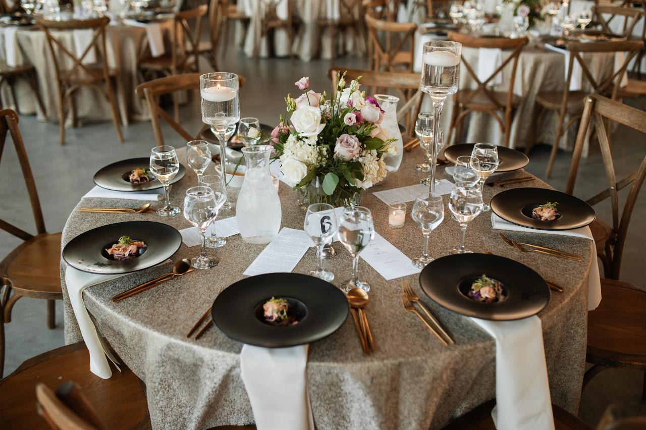 Wedding reception table with flowers and black place settings. Jewish wedding in Baltimore.