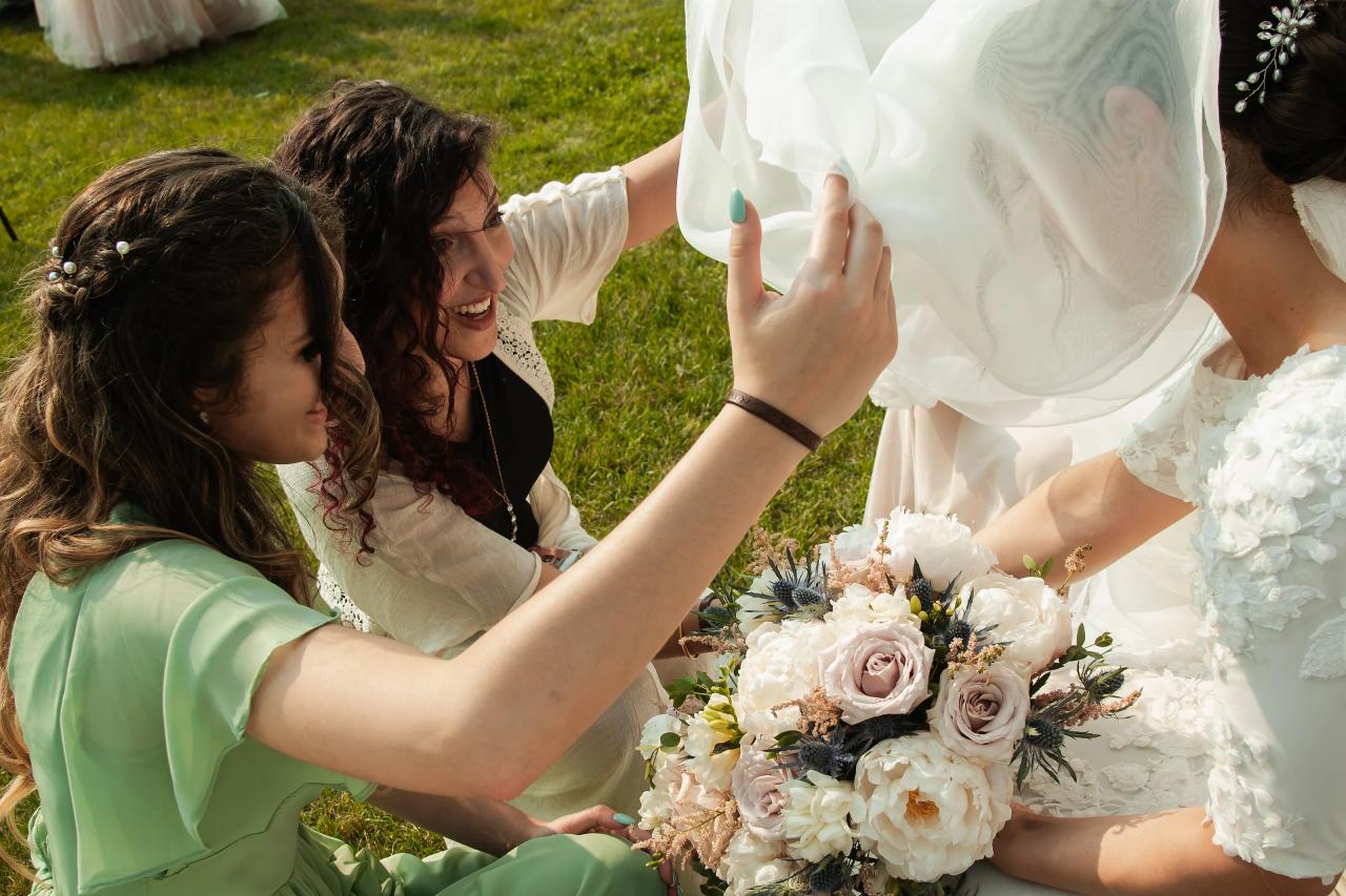 Bride receiving a family blessing before the chuppah. Wedding at Indian Ridge.