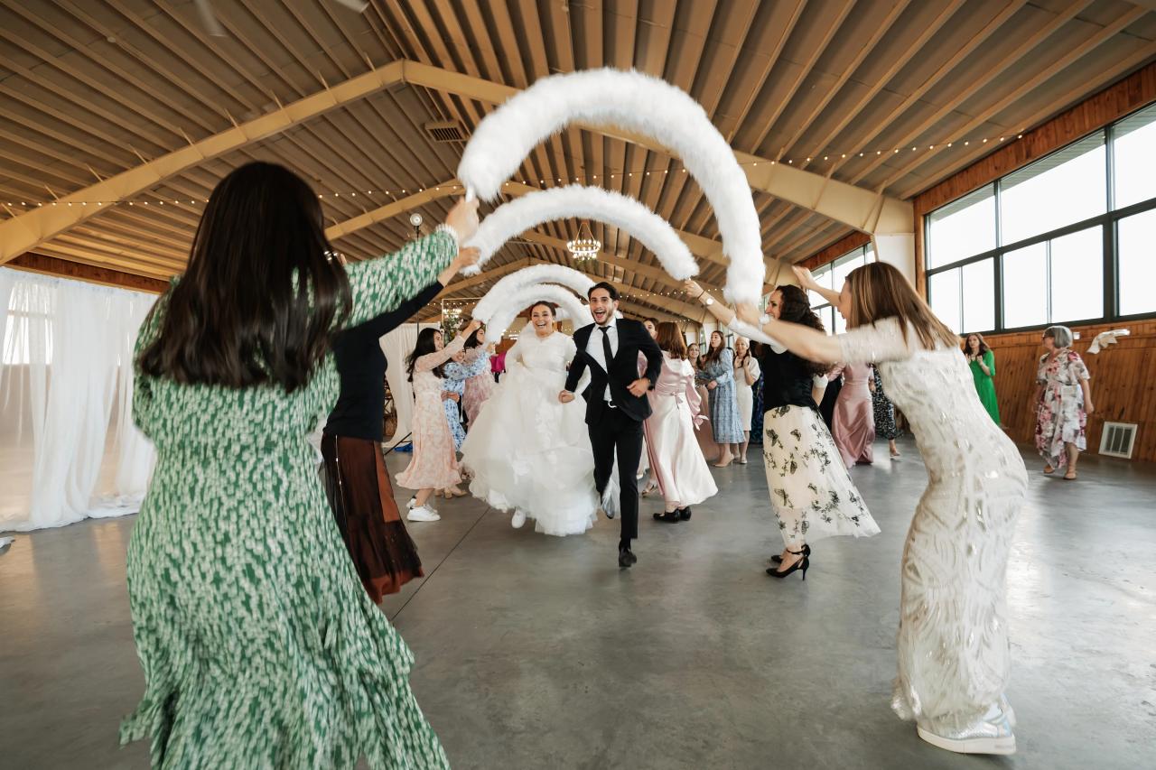 Guests welcoming the bride with raised floral hoops. Jewish wedding in Baltimore.