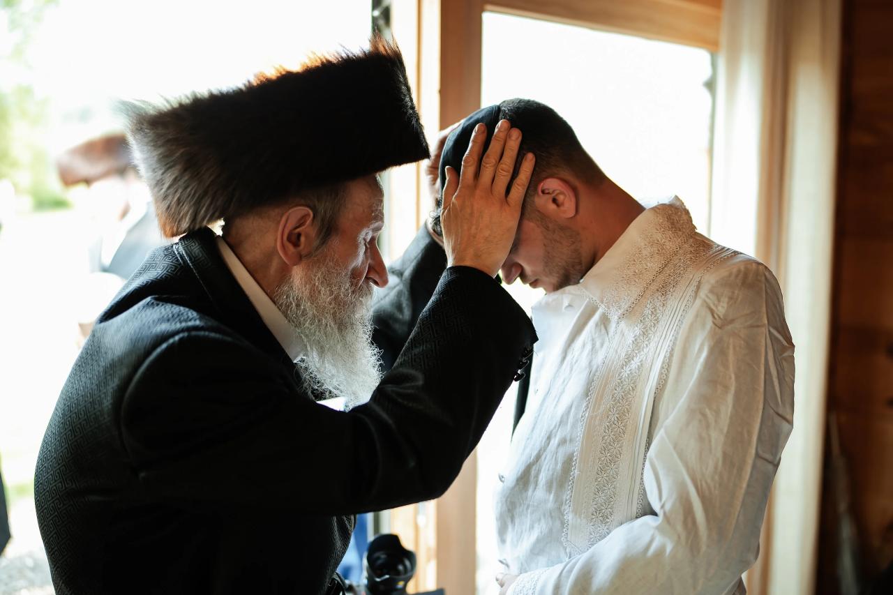 Groom receiving a blessing before the ceremony. Wedding at Indian Ridge.