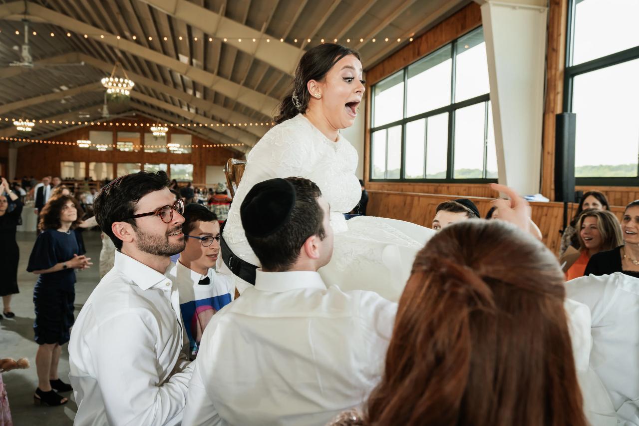 Bride lifted on a chair during the hora. Jewish wedding in Baltimore.