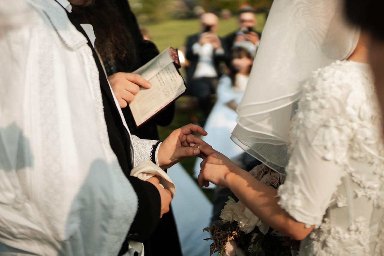 Wedding ring exchange during the lakeside ceremony. Wedding at Indian Ridge.