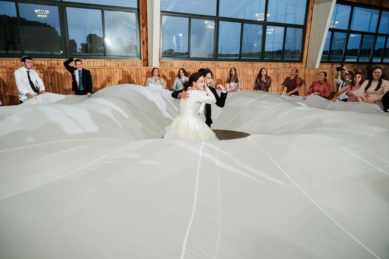 Bride and groom dancing beneath a billowing white cloth. Jewish wedding in Baltimore.
