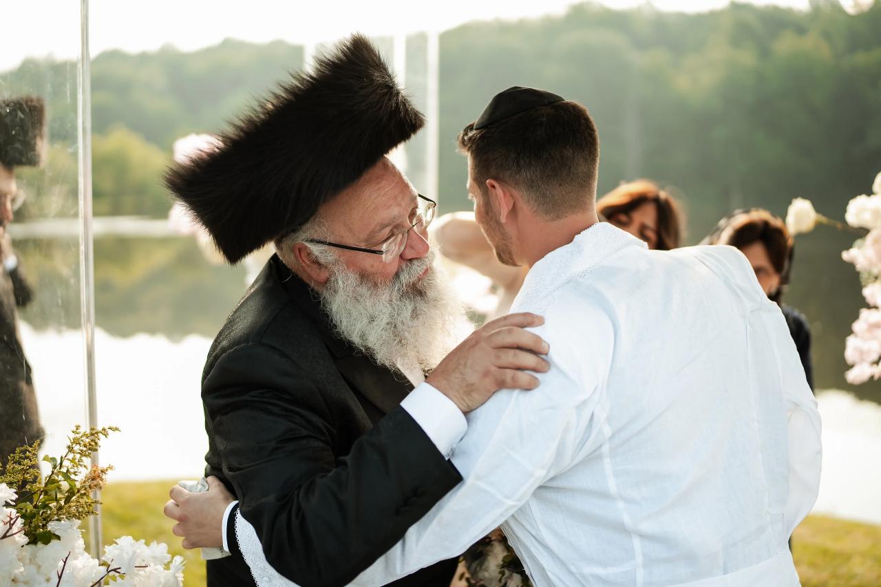 Groom embracing a family member during the ceremony. Wedding at Indian Ridge.