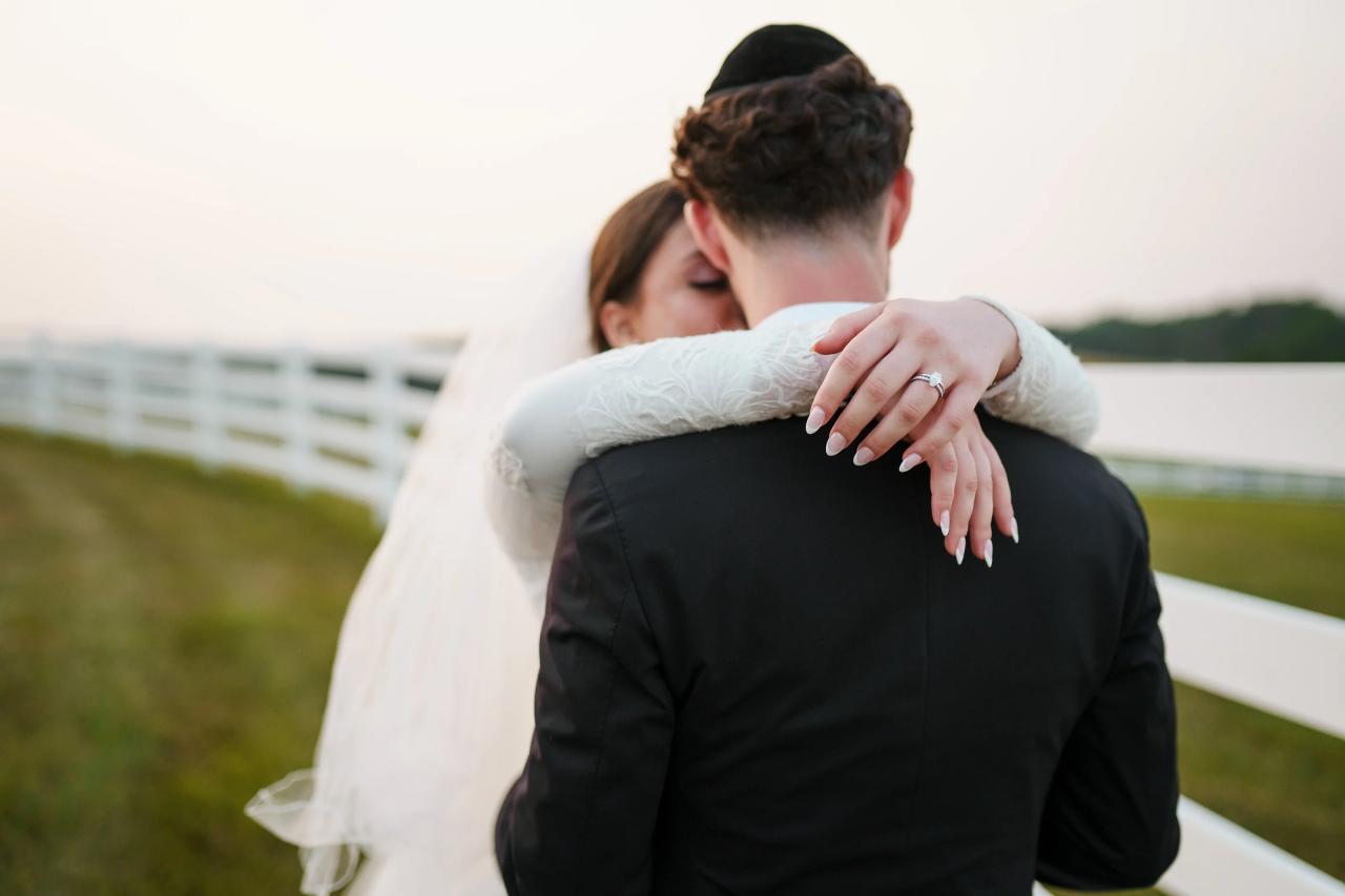 Close wedding portrait of the bride embracing the groom at dusk. Jewish wedding in Baltimore.