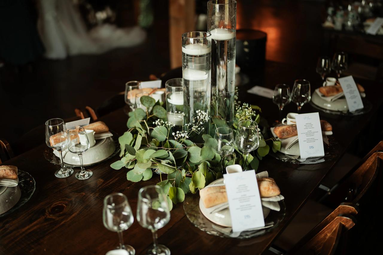 Candles and greenery decorating the wedding reception table. Wedding at Indian Ridge.