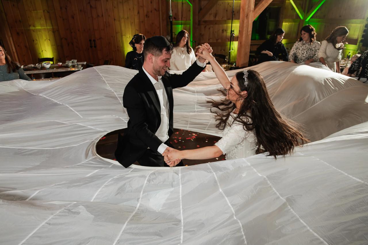 Wedding couple dancing beneath the bride’s lifted veil. Wedding at Indian Ridge.