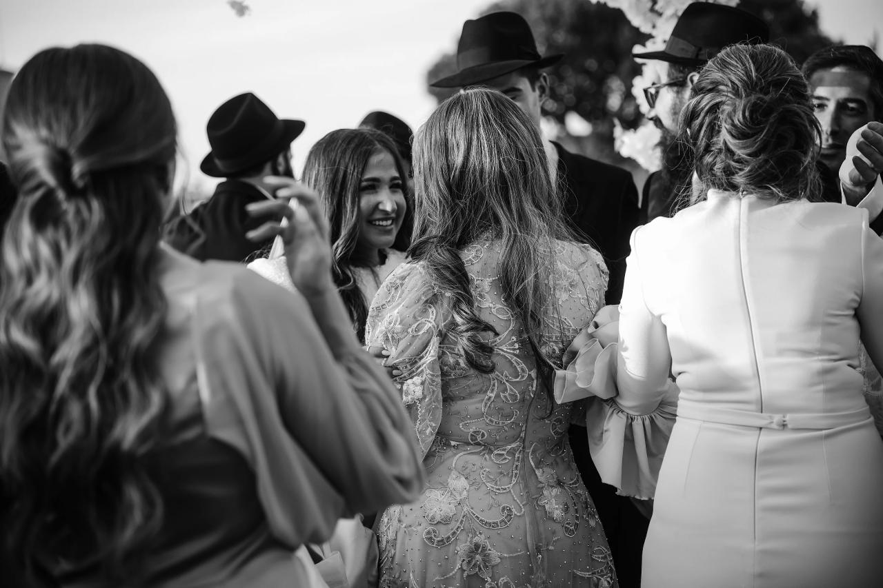 Black-and-white bride laughing among guests after the Detroit wedding ceremony