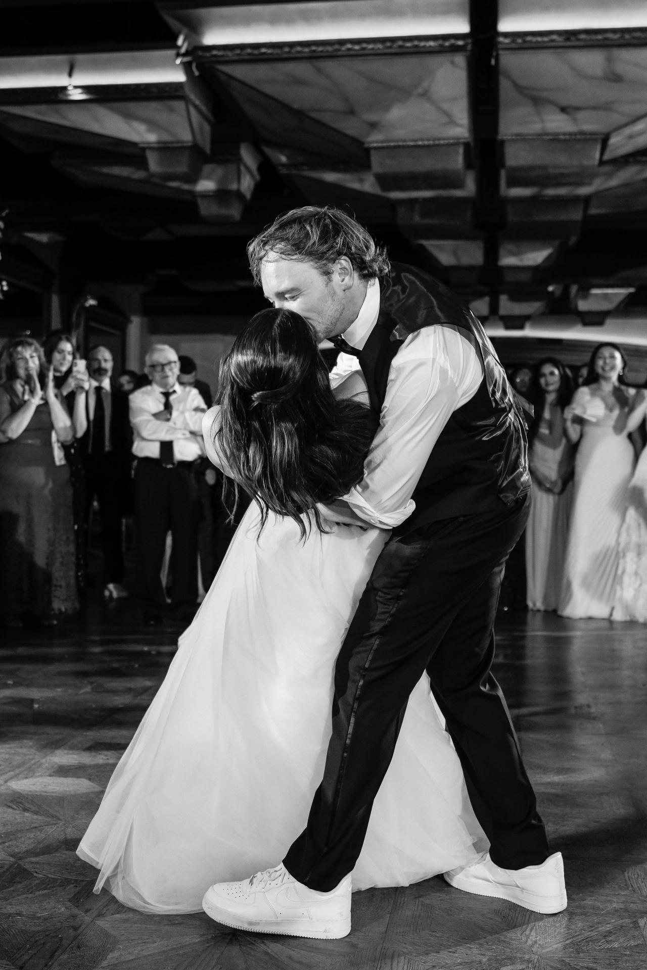 Black-and-white groom dipping the bride on the Crest Hollow reception dance floor, Woodbury, Long Island.