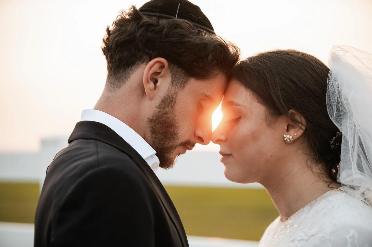 Bride and groom touching foreheads with golden sunset light between their faces at a Baltimore Jewish wedding. Wedding photography at Vignon Manor Farm, Baltimore, MD.