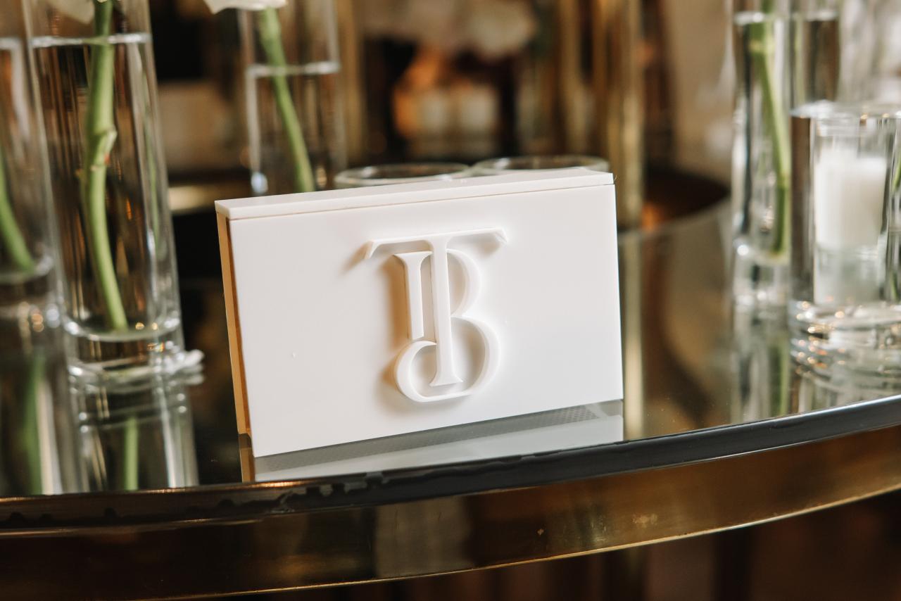 Close-up of a decorative white number “13” card on a bar shelf, with polished glassware bottles blurred in the background. Bar Mitzvah photography at Hilton Garden Inn Springfield, Springfield, NJ.