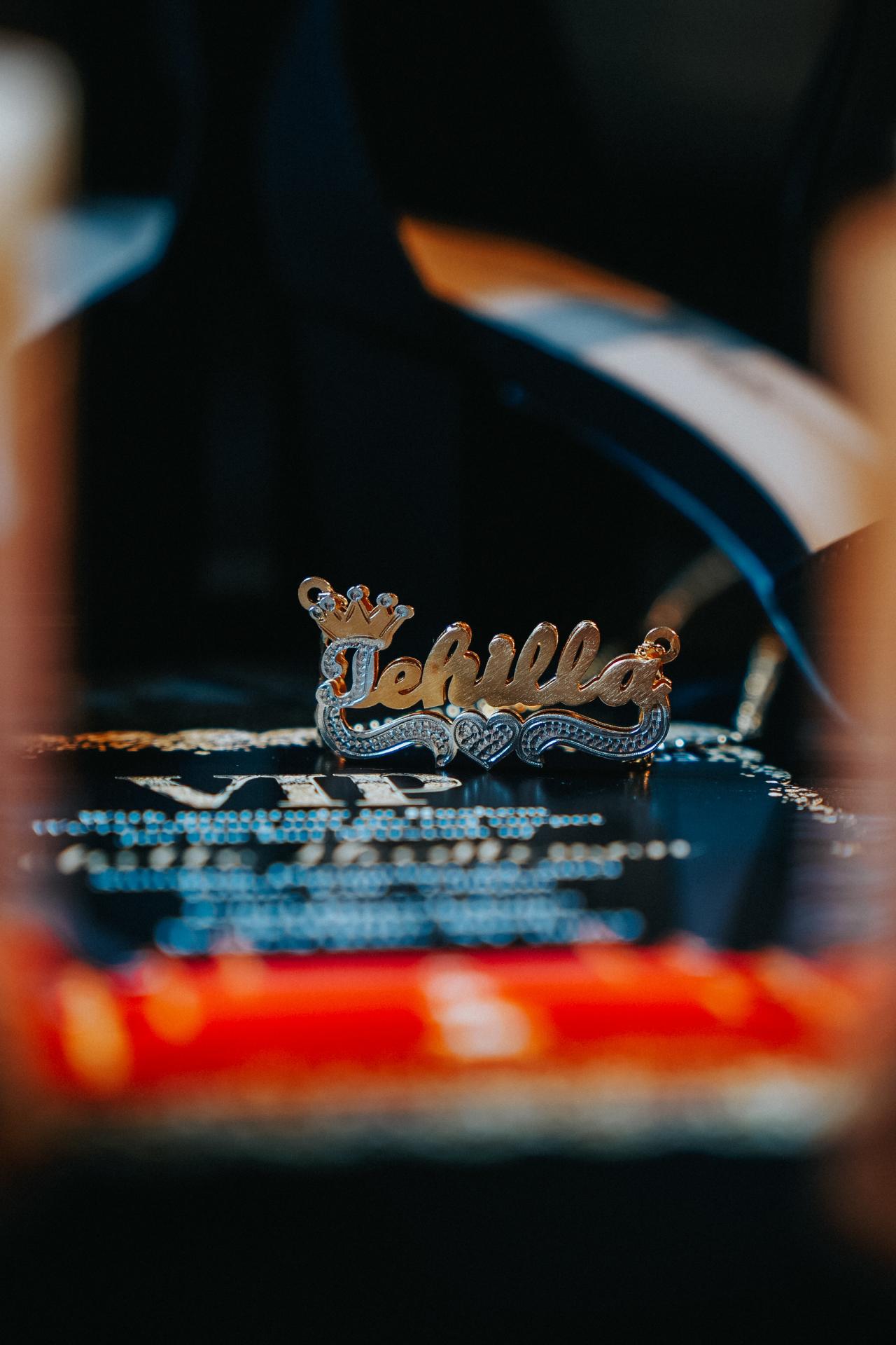 Shallow depth-of-field close-up of “Mazal Tov” decorative sign with soft bokeh lights in the background.