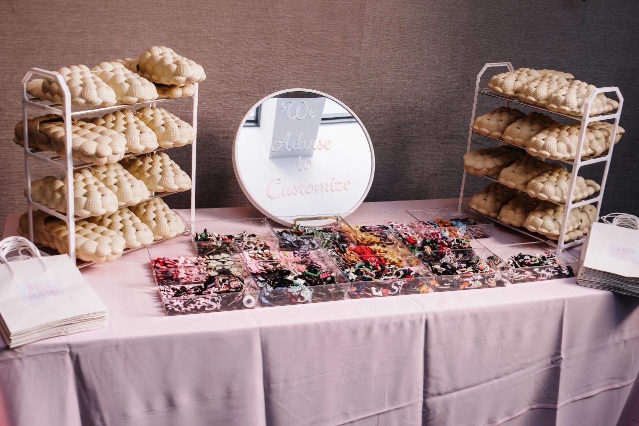 Overhead view of a styled dessert/candy station table with assorted sweets and cookie trays on display. Bat Mitzvah photography at Doubletree By Hilton Hotel Fort Lee - George Washington Bridge, Fort Lee, NJ.