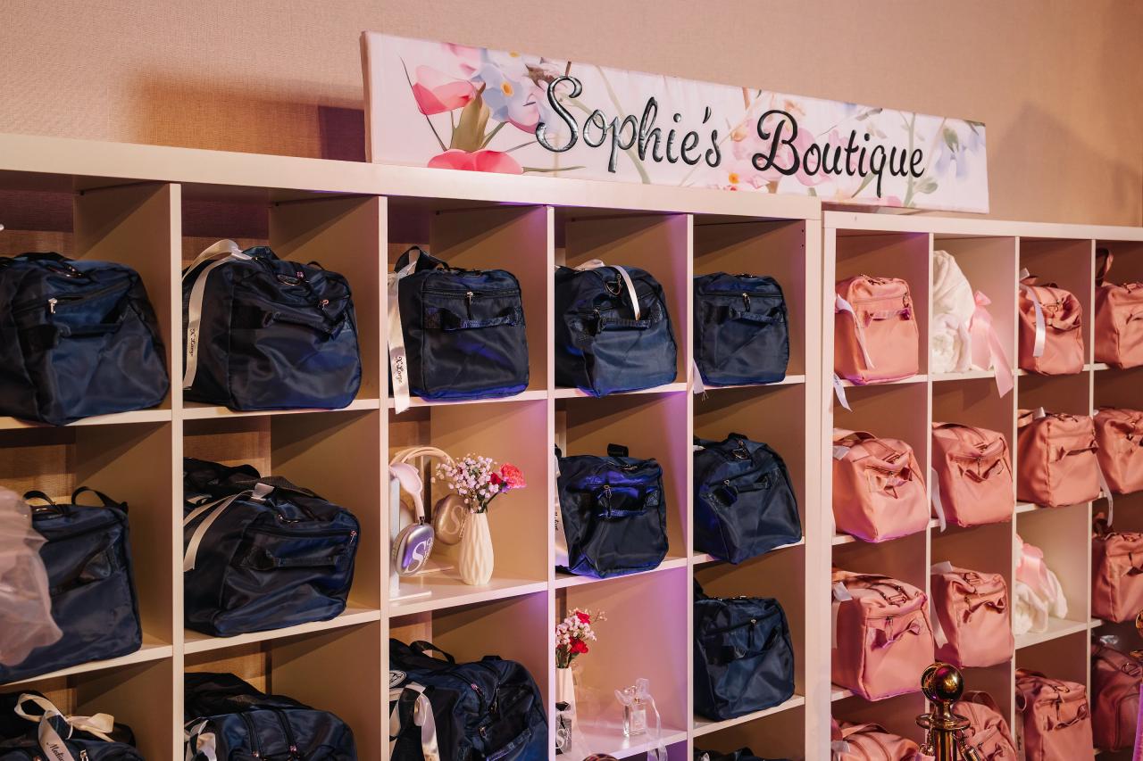 Boutique display shelf with multiple gift bags in navy and pink with a sign reading “Sophies Boutique.”. Bat Mitzvah photography at Doubletree By Hilton Hotel Fort Lee - George Washington Bridge, Fort Lee, NJ.