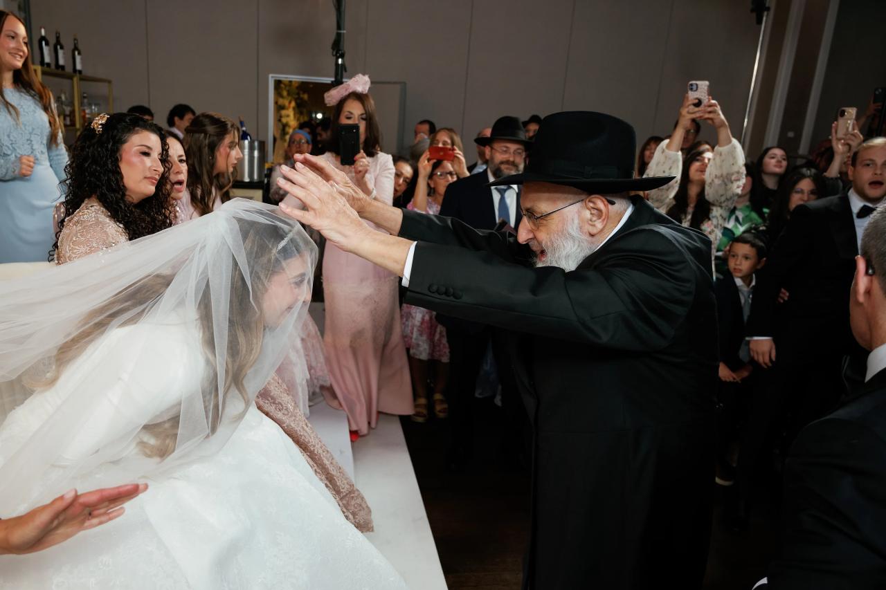A blessing over the veiled bride before the ceremony. Wedding photography at Brightstone, Passaic, NJ.