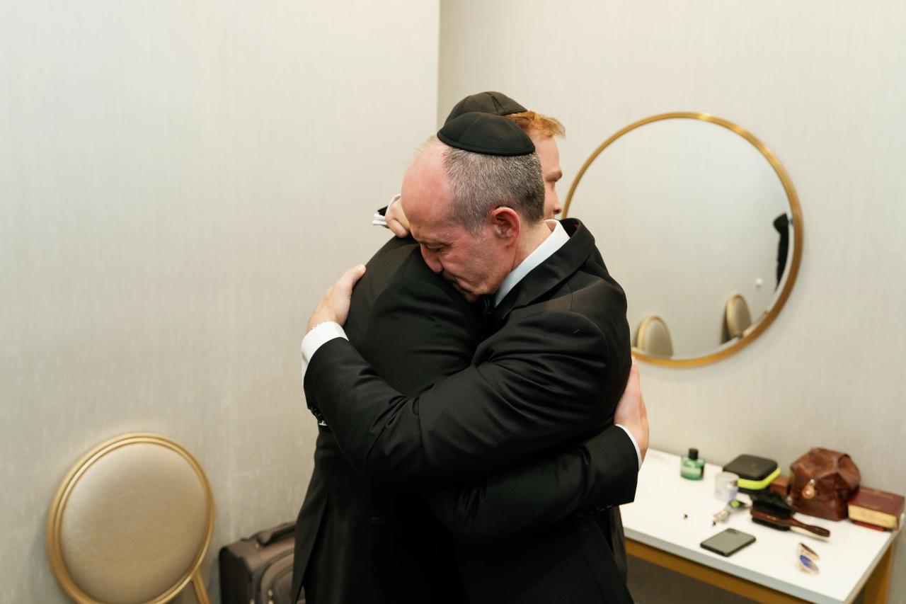 A quiet family blessing and embrace with the groom. Wedding photography at Brightstone, Passaic, NJ.