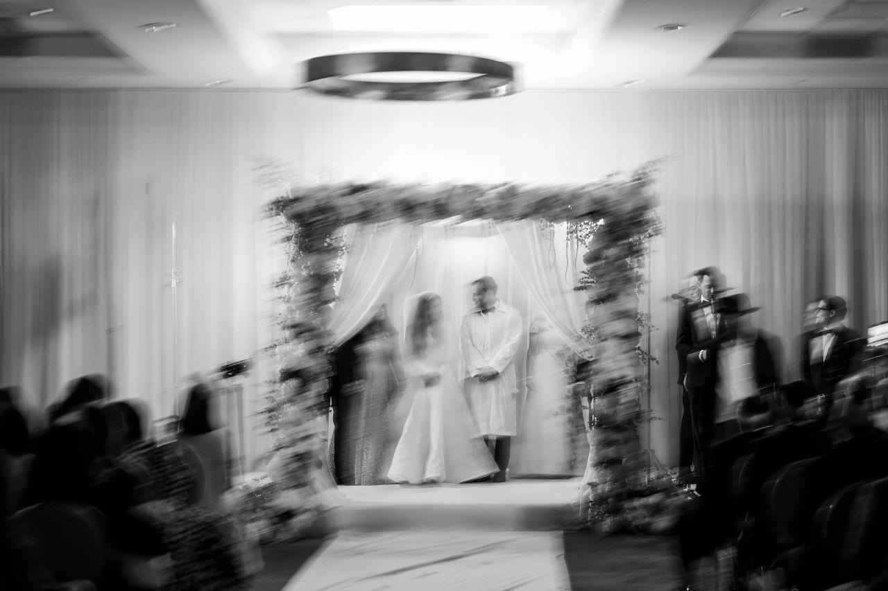 An expressive black-and-white chuppah photograph with intentional radial motion blur. Wedding photography at Brightstone, Passaic, NJ.