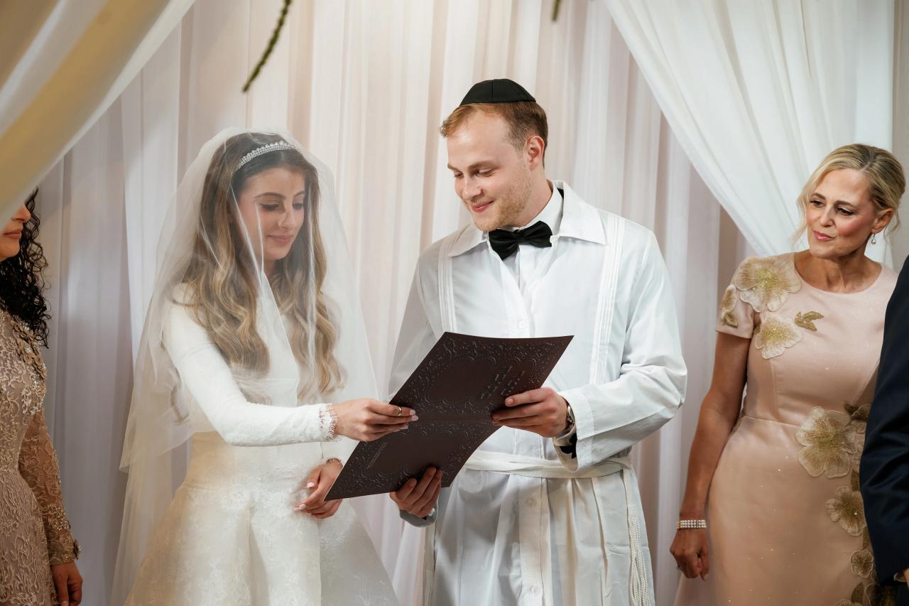 The couple shares a wedding-document moment beneath the chuppah. Wedding photography at Brightstone, Passaic, NJ.