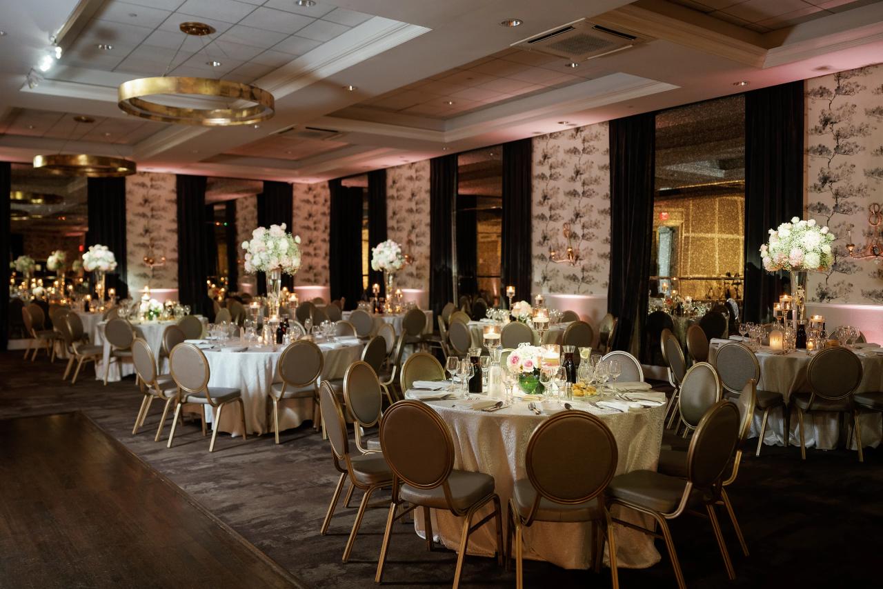 Wide view of the Brightstone Hall reception room with floral tables and stone surfaces. Wedding photography.