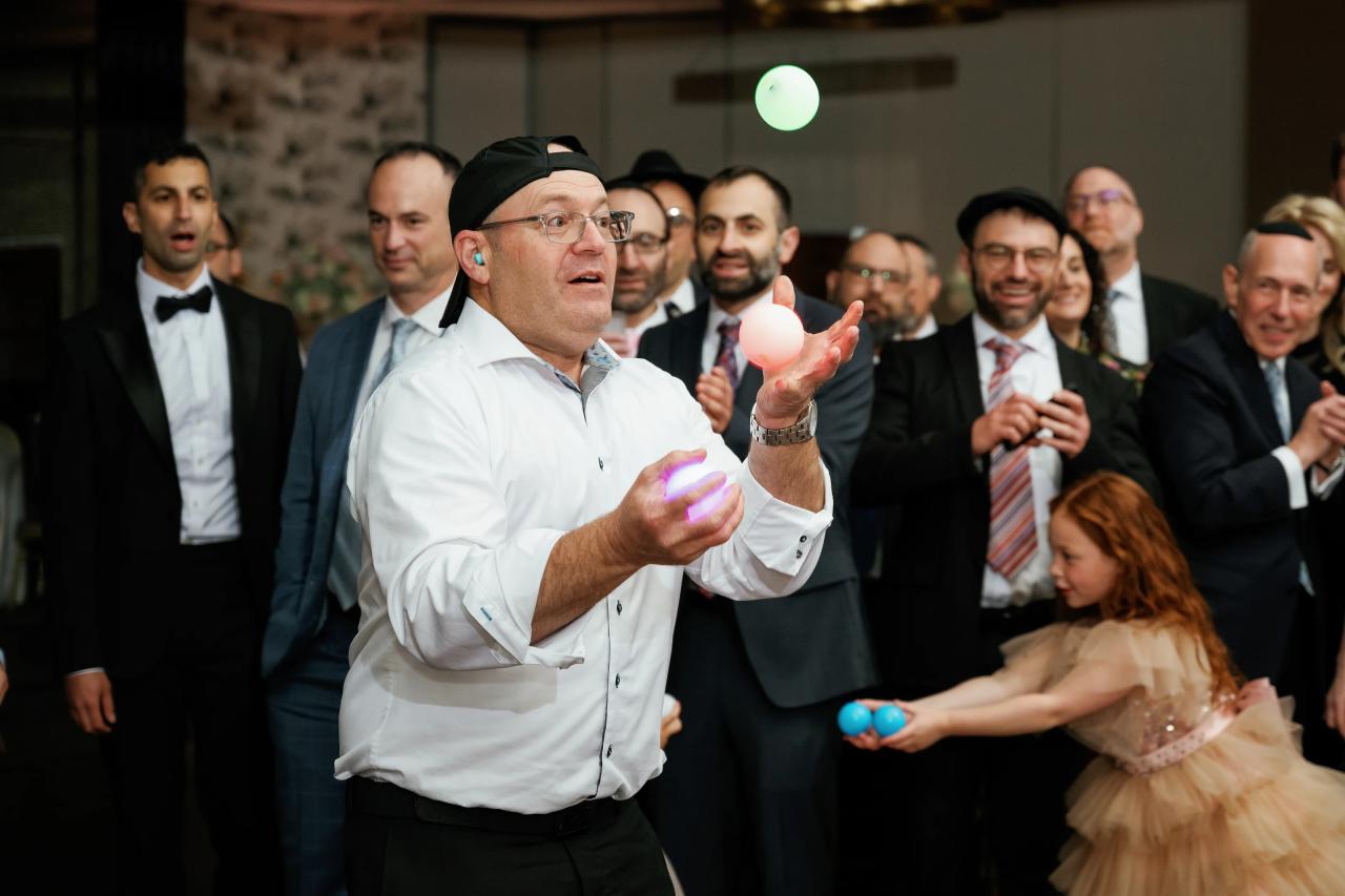 A playful reception performance draws reactions from the surrounding guests. Wedding photography at Brightstone, Passaic, NJ.