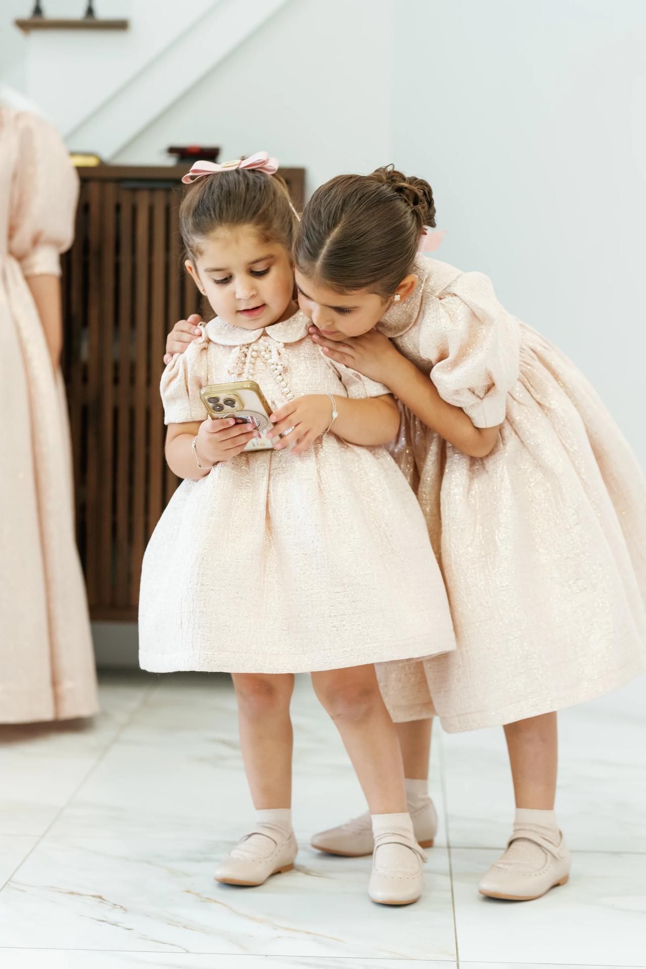 An affectionate sibling kiss during the family preparations, before the Eagle Ridge bar mitzvah. Bar Mitzvah photography.
