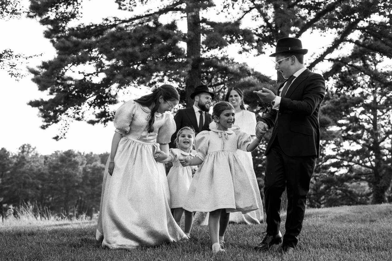 A black-and-white family photograph beneath the garden trees. Bar Mitzvah photography at Eagle Ridge, Lakewood, NJ.