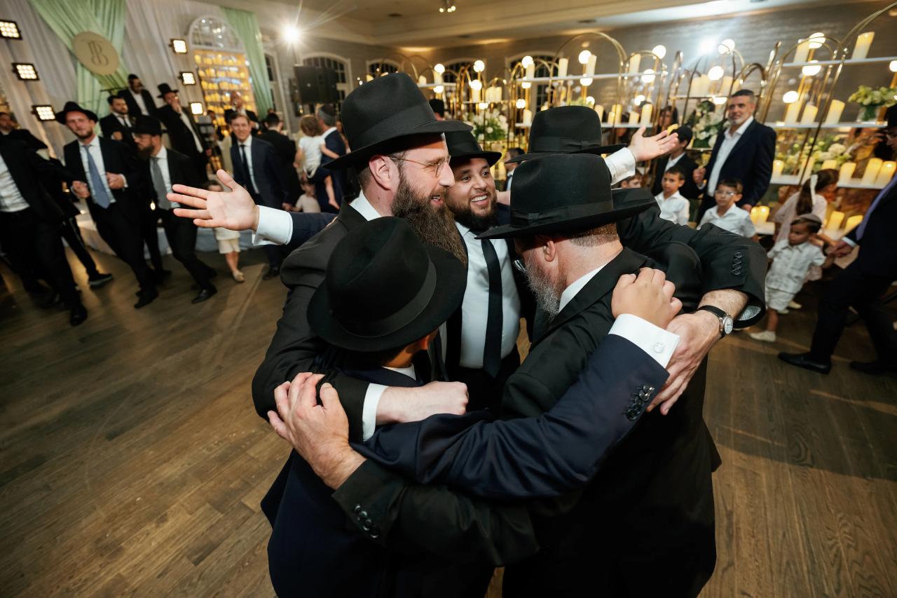 The celebrant dances closely with guests around him. Bar Mitzvah photography at Eagle Ridge, Lakewood, NJ.