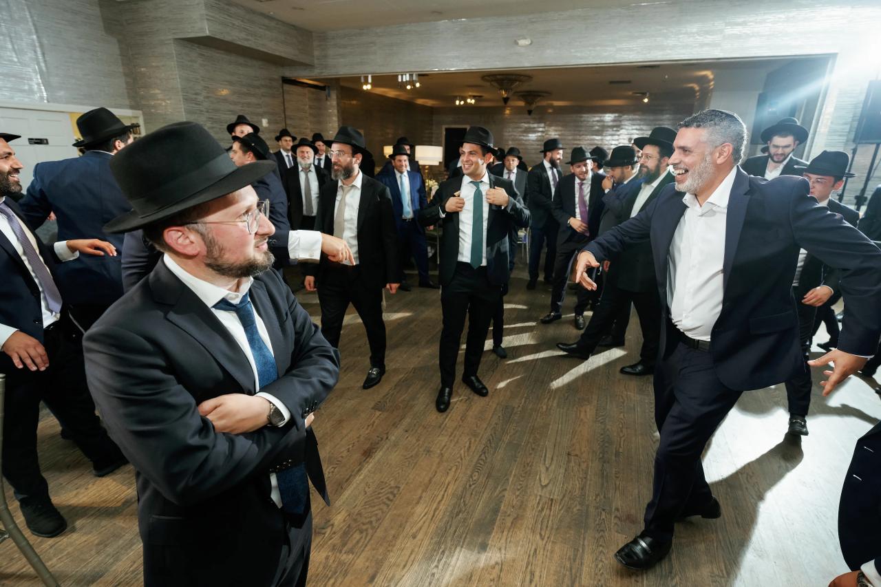 Guests laugh and dance together, with layered faces across the frame. Bar Mitzvah photography at Eagle Ridge, Lakewood, NJ.