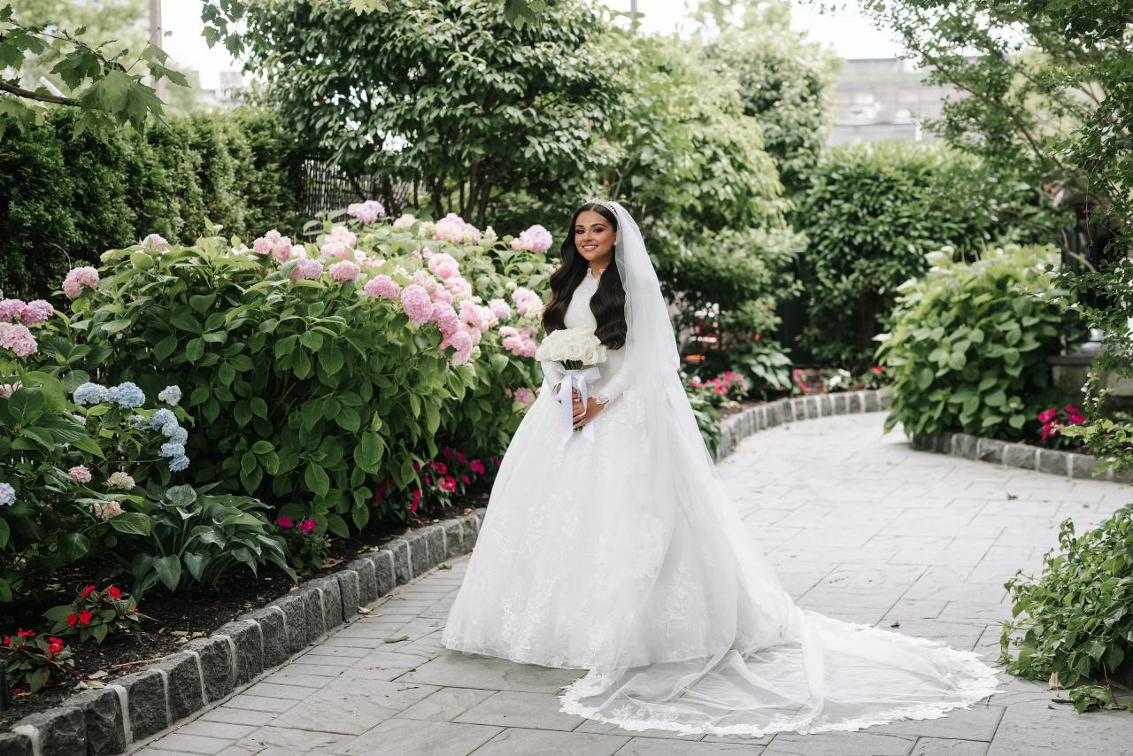 The bride’s full wedding gown framed by hydrangeas. Wedding photography at Brightstone, Passaic, NJ.