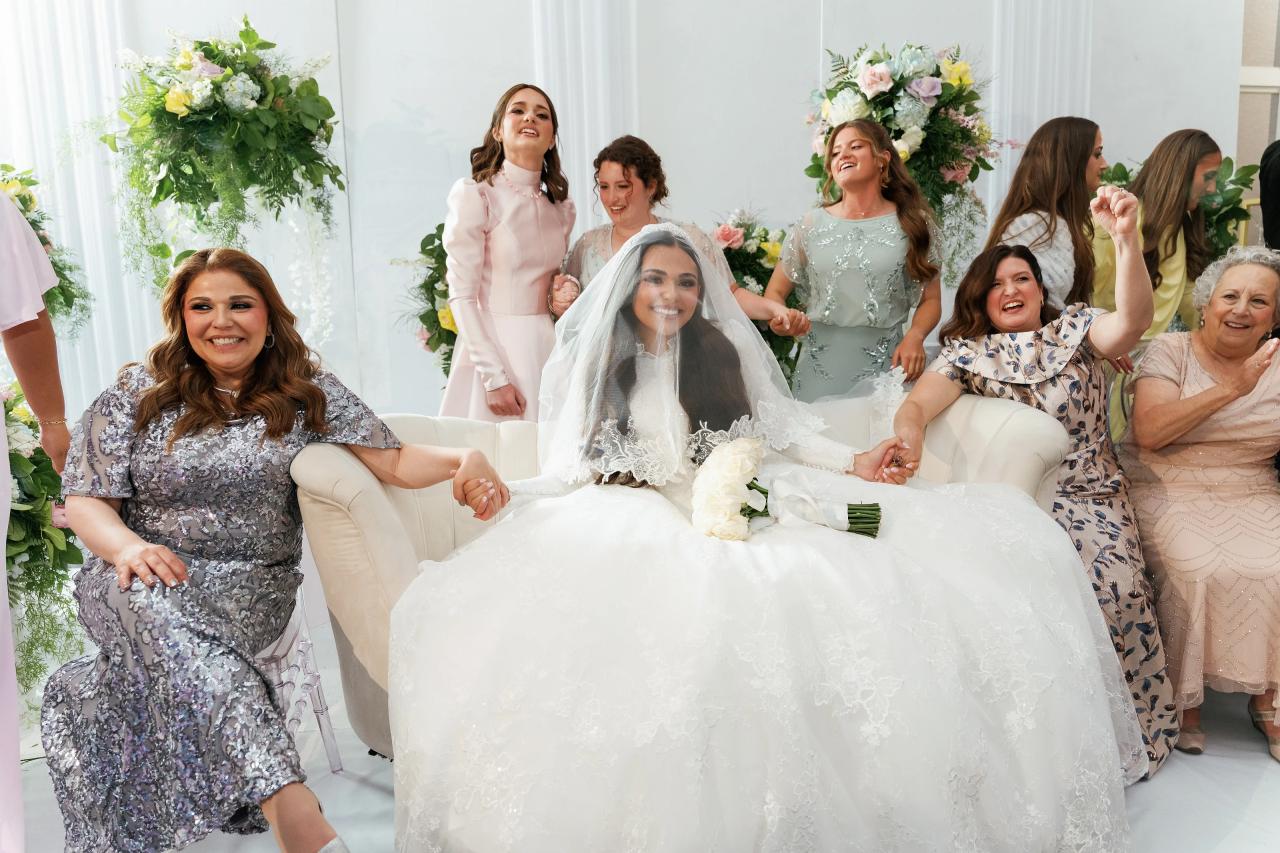 Family surrounds the bride during the bedeken celebration. Wedding photography at Brightstone, Passaic, NJ.