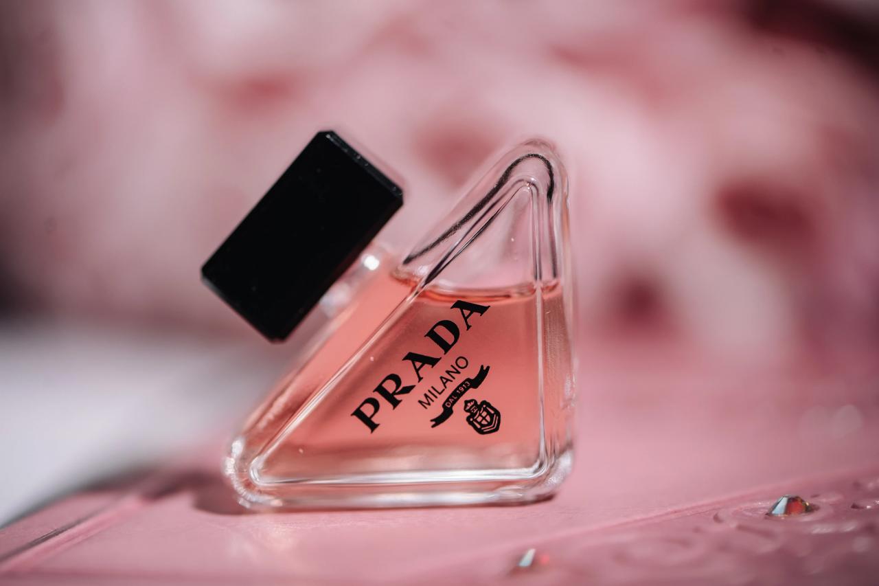 Close-up of a clear perfume bottle with a pink label, shot with shallow depth of field. Wedding photography at The Palace, Brooklyn, NY.