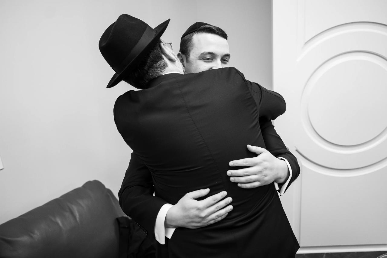 Black-and-white embrace before the wedding ceremony. From this Lake Terrace wedding. Wedding photography.
